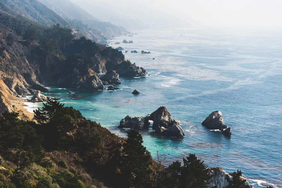 Secluded California cove and golden hills at sunset
